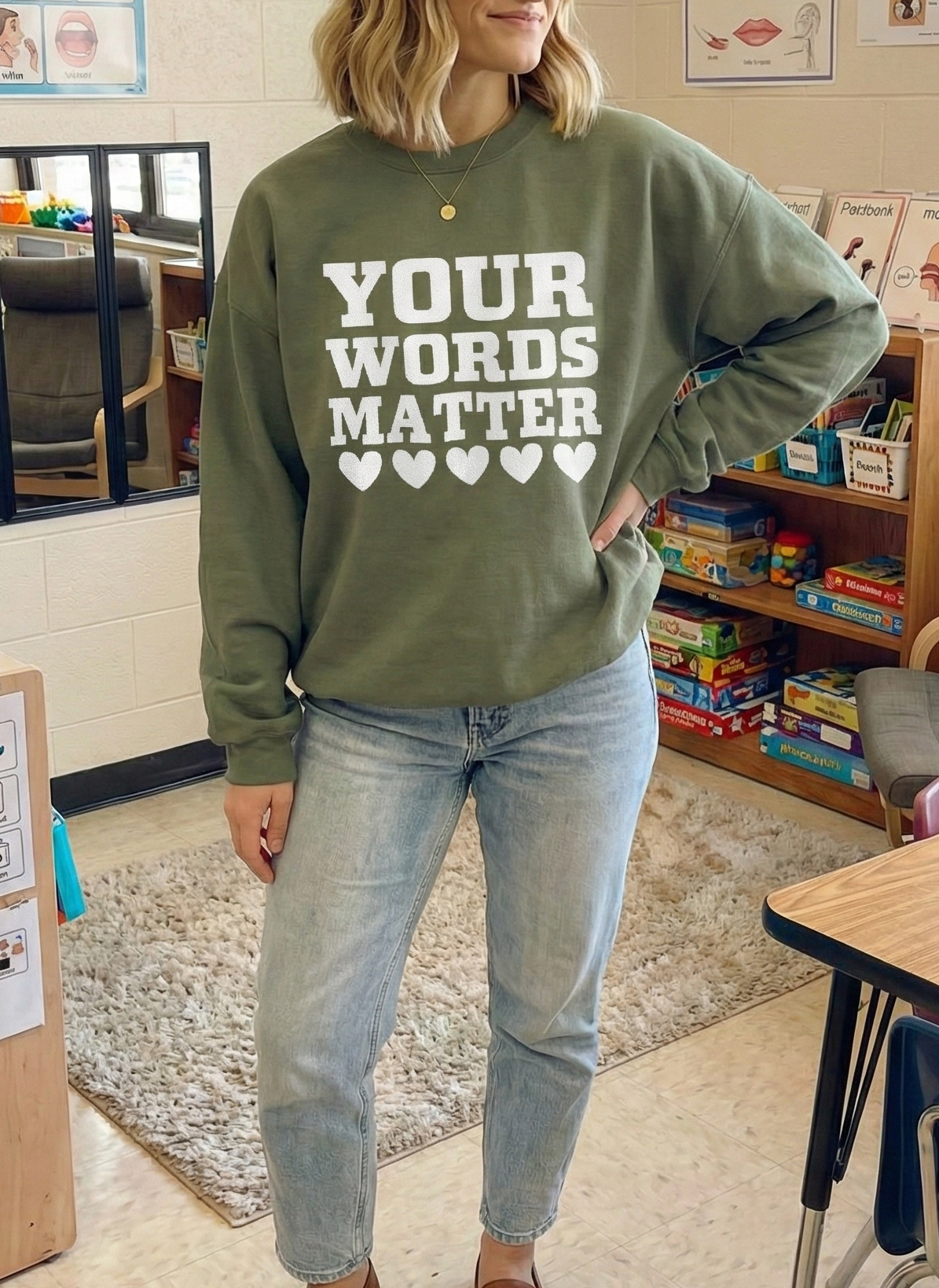 Person wearing a green sweatshirt with 'Your Words Matter' text in a classroom setting