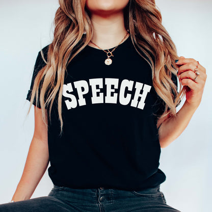 Person wearing a black t-shirt with 'SPEECH' printed on it against a plain background