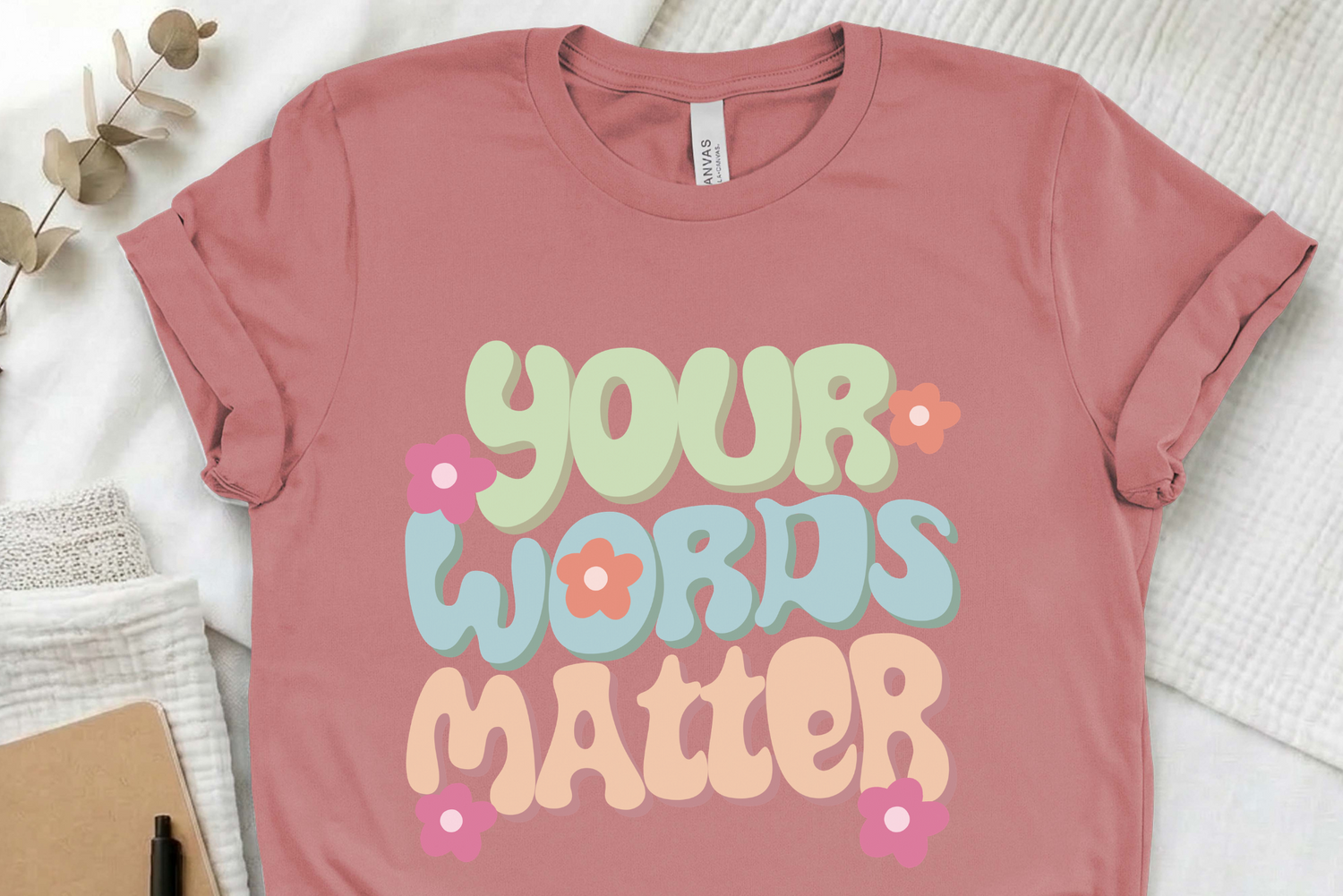 Pink t-shirt with 'Your Words Matter' text on a light background